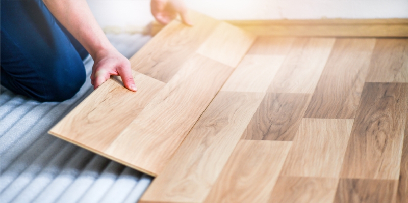 A worker installing laminate flooring